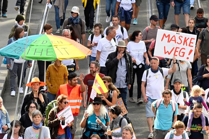 People take part in a demonstration called by far-right and COVID-19 deniers to protest against restrictions related to the new coronavirus pandemic, on August 29, 2020 in Berlin. (Photo by John MACDOUGALL / AFP)