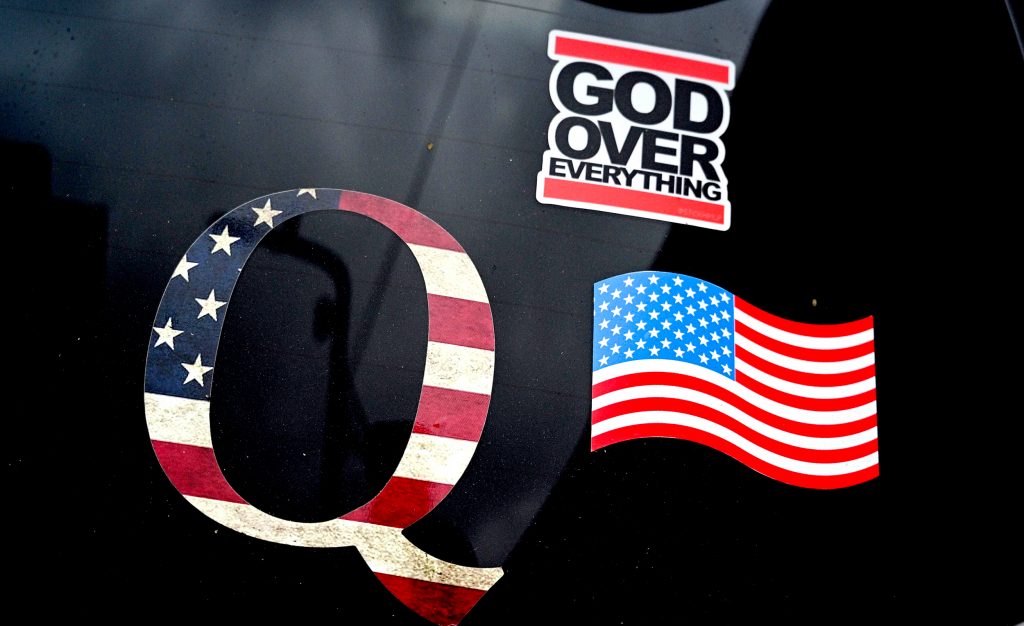 A QAnon sticker is seen on the back of a car on November 6, 2020 in Los Angeles as the entire nation awaits the result of the presidential election. - President Donald Trump, in his latest effort to discredit vote tallies showing him headed for defeat in the tense US election, warned challenger Joe Biden on November 6 against "wrongfully" claiming the presidency.Three days after the US election in which there was a record turnout of 160 million voters, a winner had yet to be declared. (Photo by Robyn Beck / AFP) (Photo by ROBYN BECK/AFP via Getty Images)